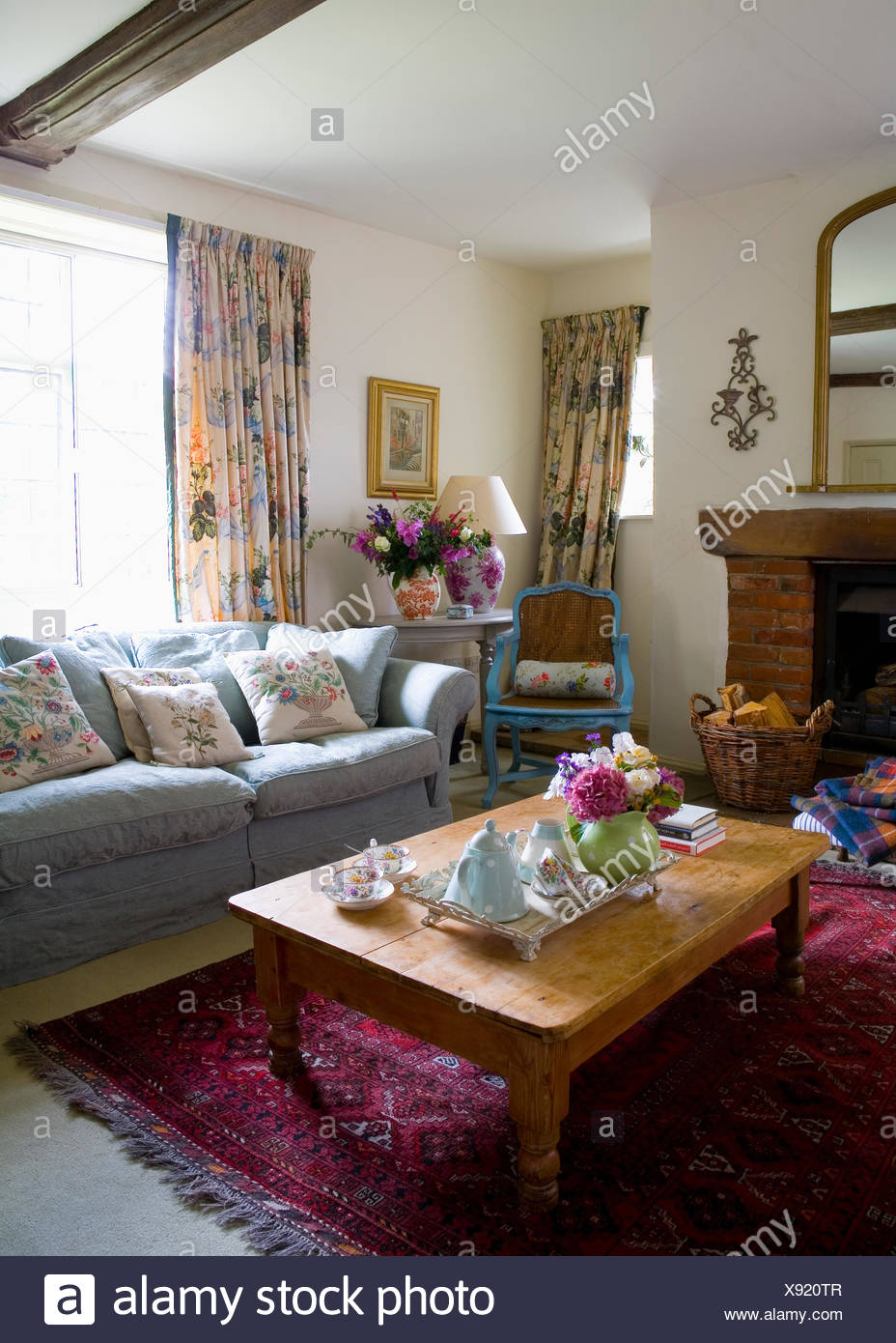 Blue Sofa In Front Of Window With Floral Curtains In Country