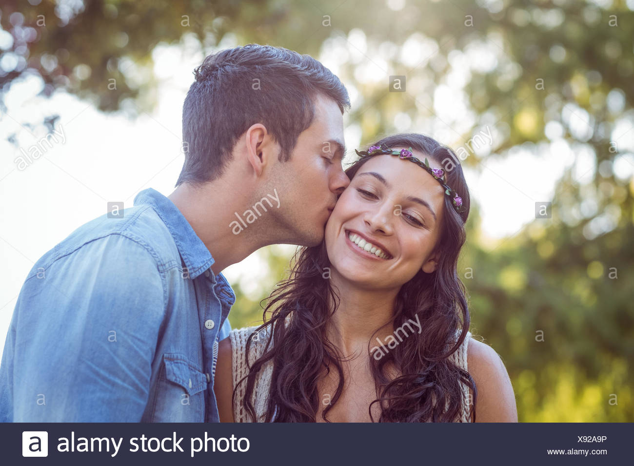 cute couple kissing in the park stock photo alamy https www alamy com cute couple kissing in the park image280949810 html