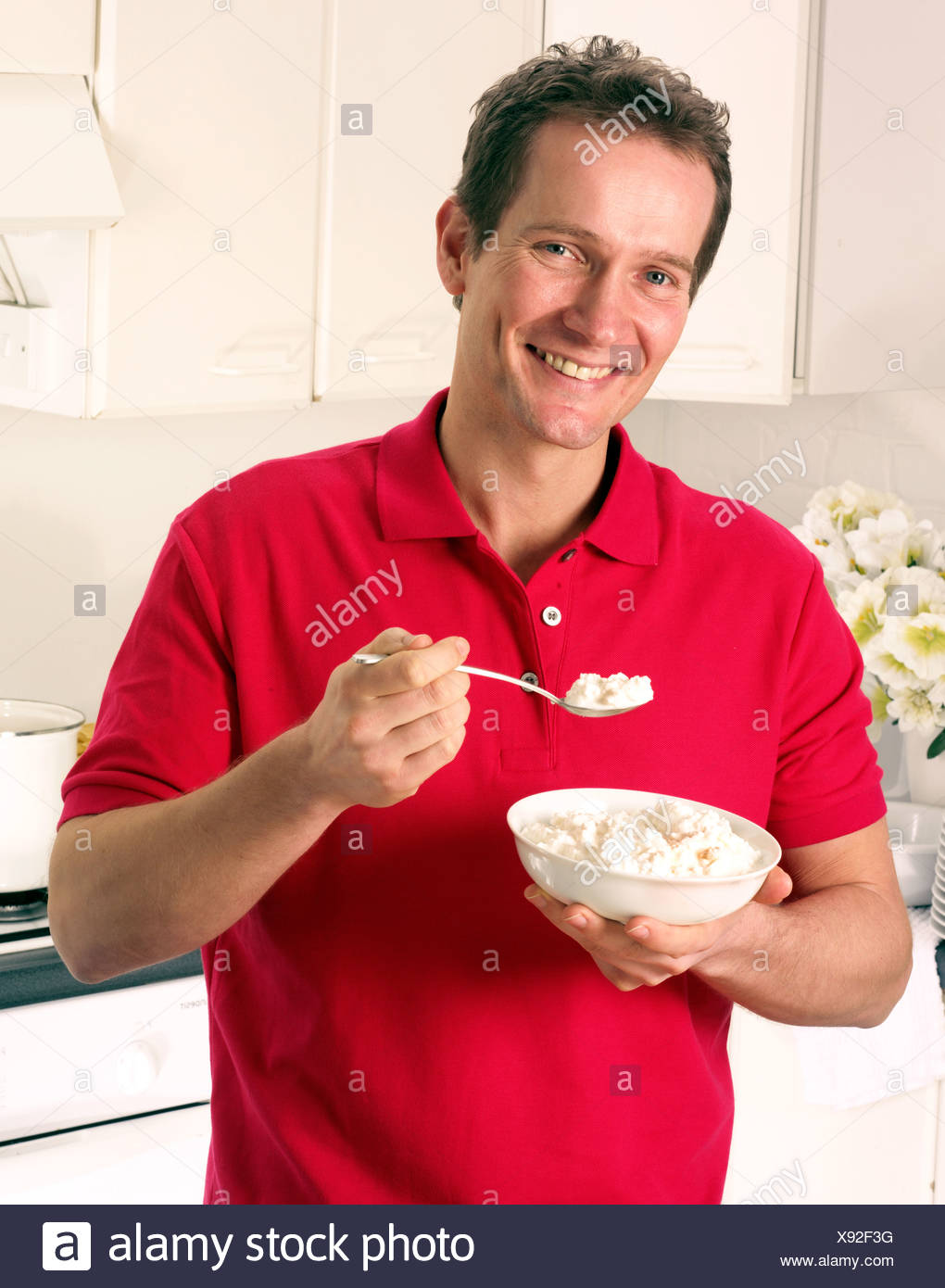 Man In Kitchen Eating Cottage Cheese Stock Photo 280953556 Alamy