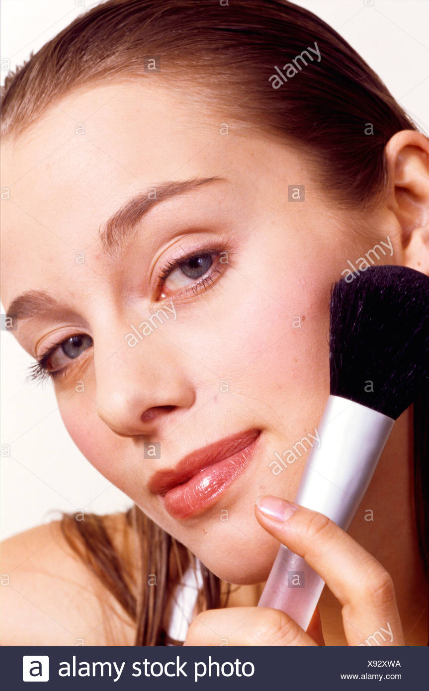 Female Long Dark Blonde Hair Slicked Back Off Face Wearing Pink