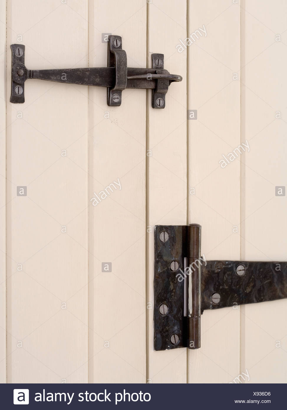 Close Up Of Cream Cottage Door With Wrought Iron Latch And Hinge