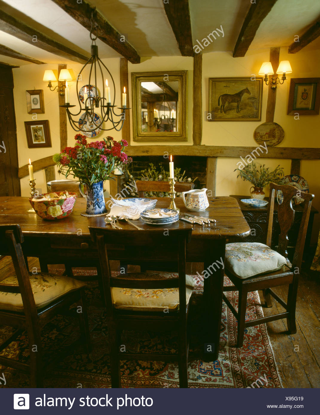 Oak Table And Chairs In Beamed Yellow Cottage Dining Room With