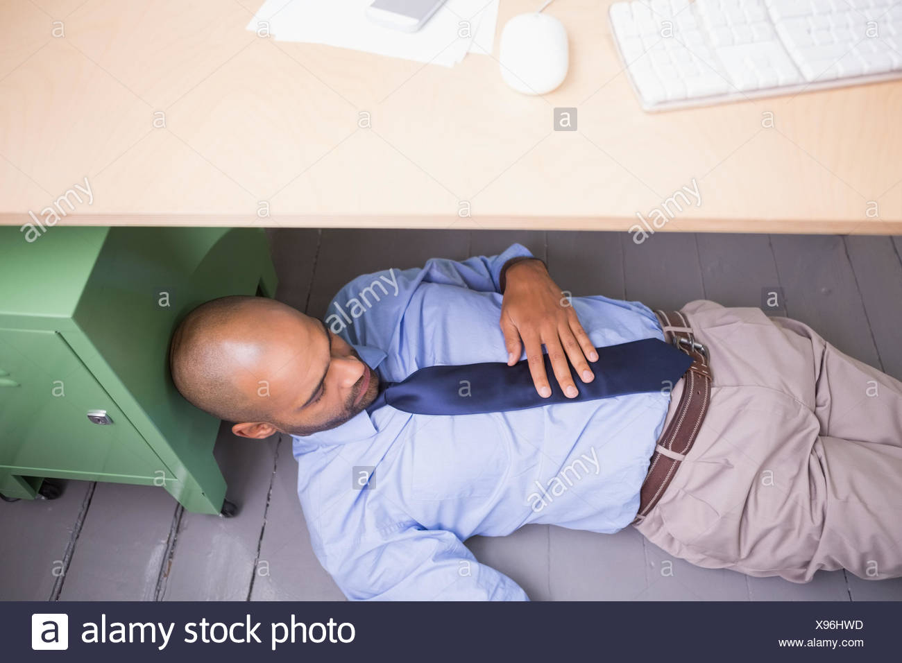 Businessman Sleeping Under Desk Stock Photo 281043545 Alamy