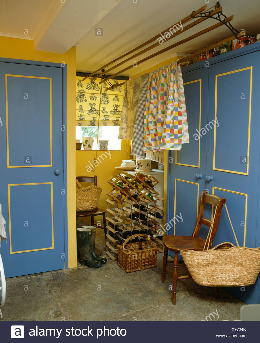 Towels On Ceiling Rack In Small Yellow Cottage Utility Room