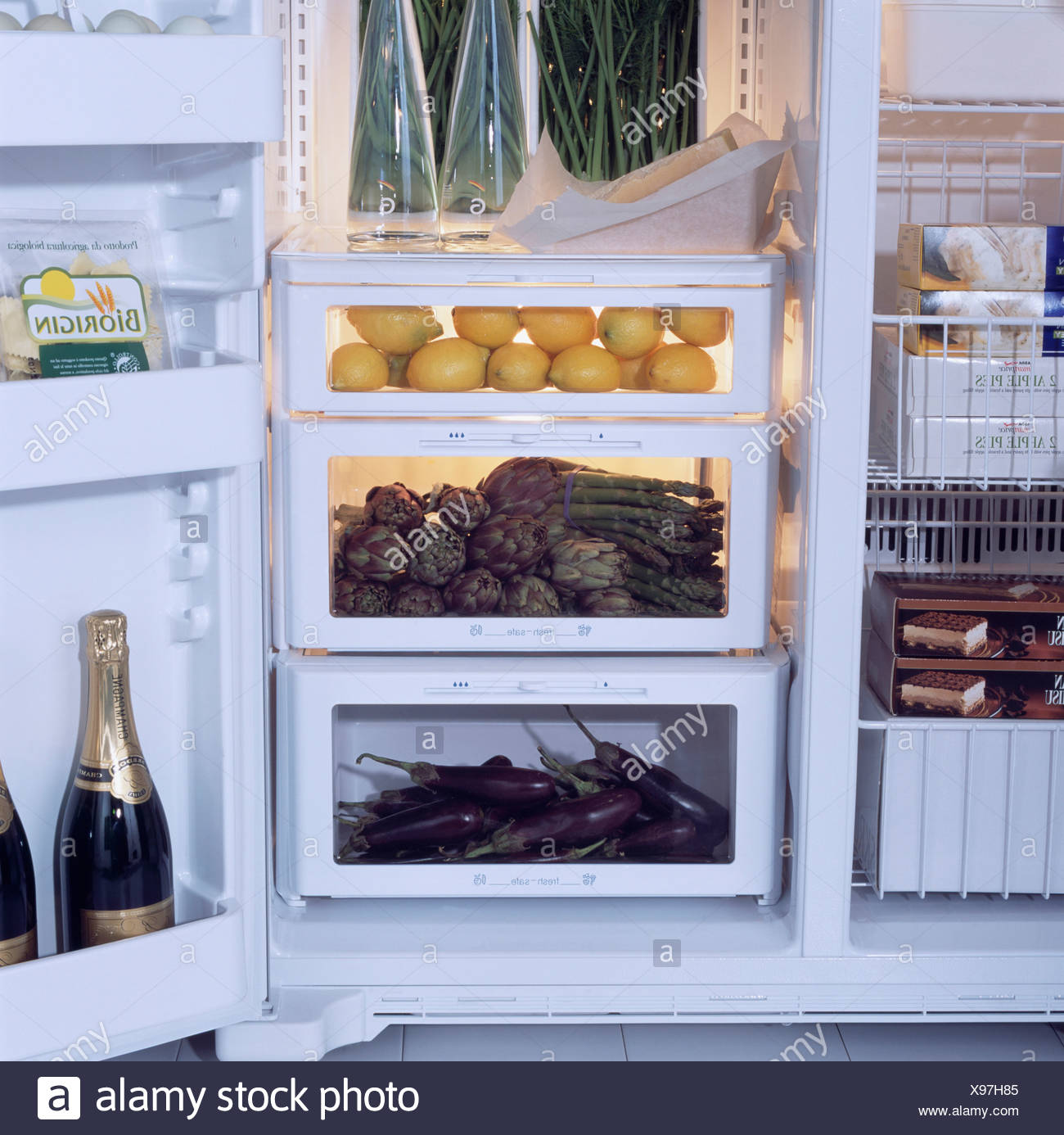 Close Up Of Vegetables And Fruit Stored In Clear Drawers In Fridge