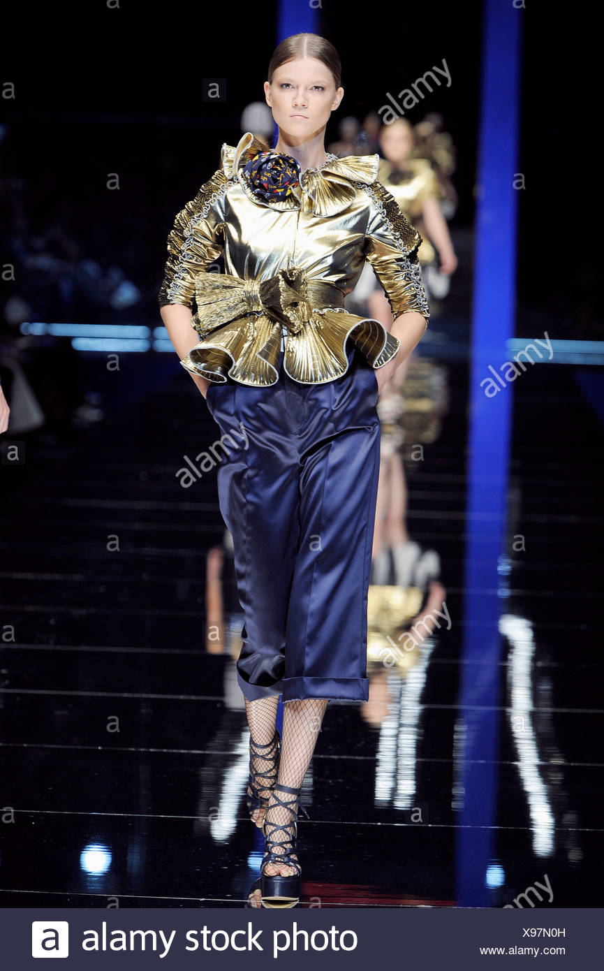 D&G Milan Ready to Wear Spring Summer Metallic gold fluted top, with satin  blue cropped trousers, fishnets and laceup platforms Stock Photo - Alamy