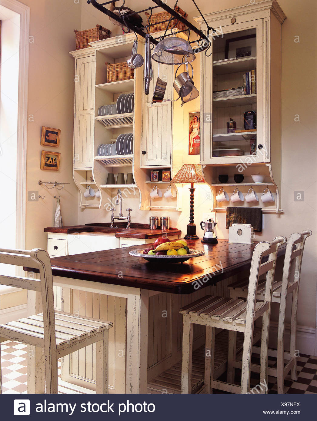 aldi white cabinet on Kitchen White Painted Walls Brown And White Check Tiled Floor Fitted Wood Storage Cuboards Painted White Dark Wood Work Top Stock Photo Alamy