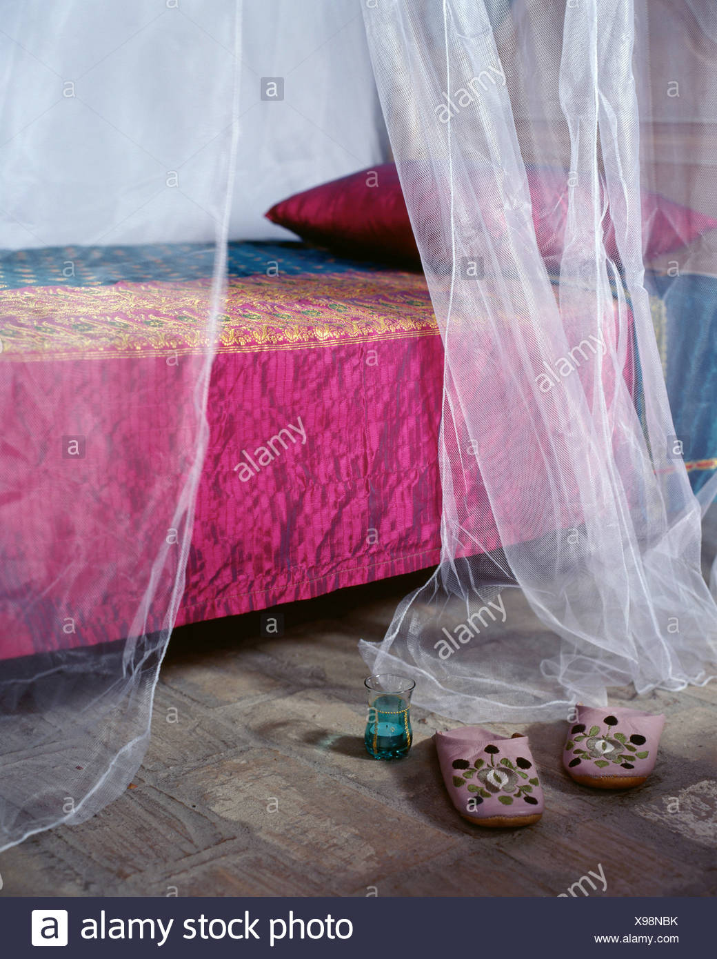 Bed With Pink Embroidered Cover And Pillow White Sheer Curtains