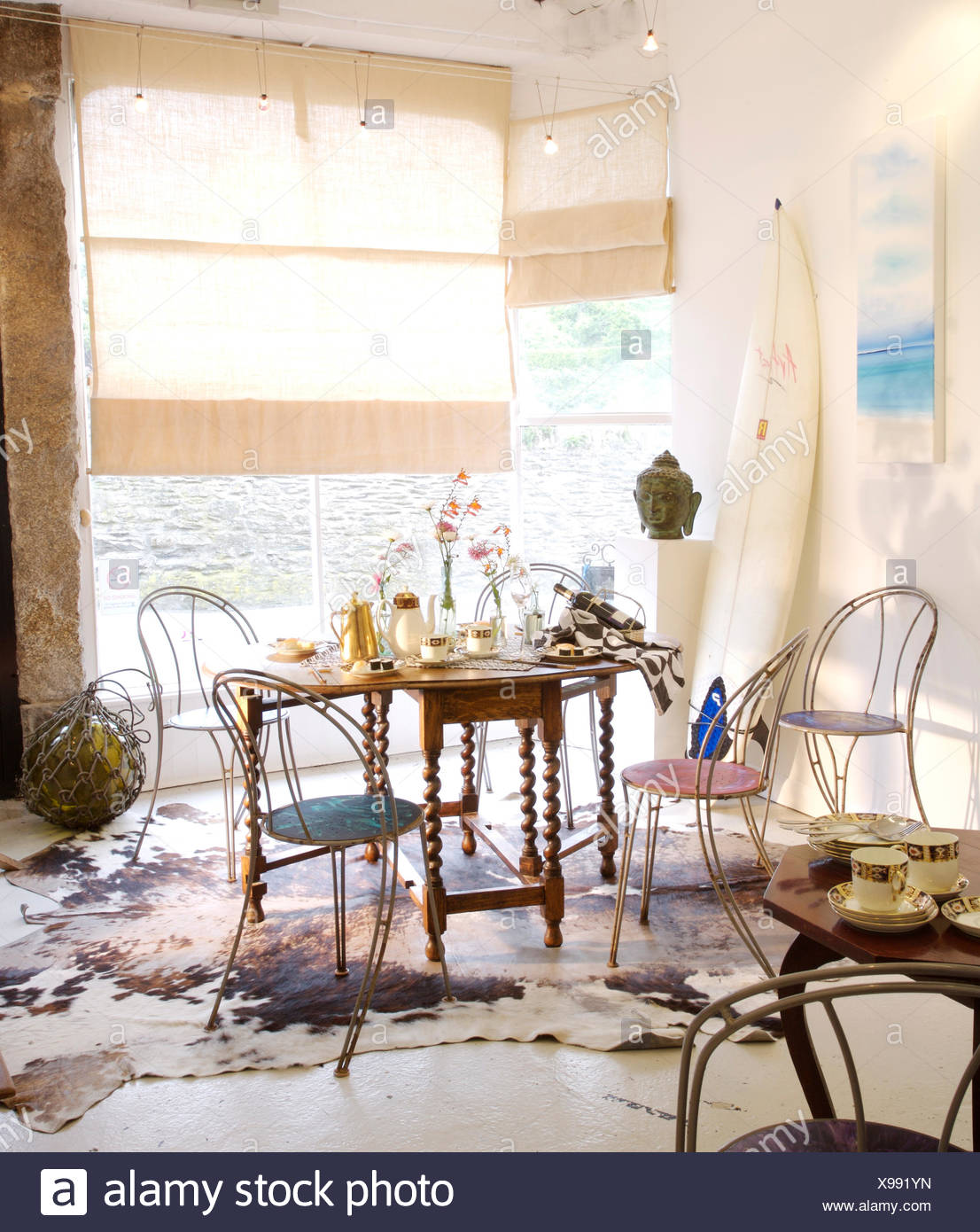 Metal Chairs At Jacobean Style Table In Coastal Dining Room