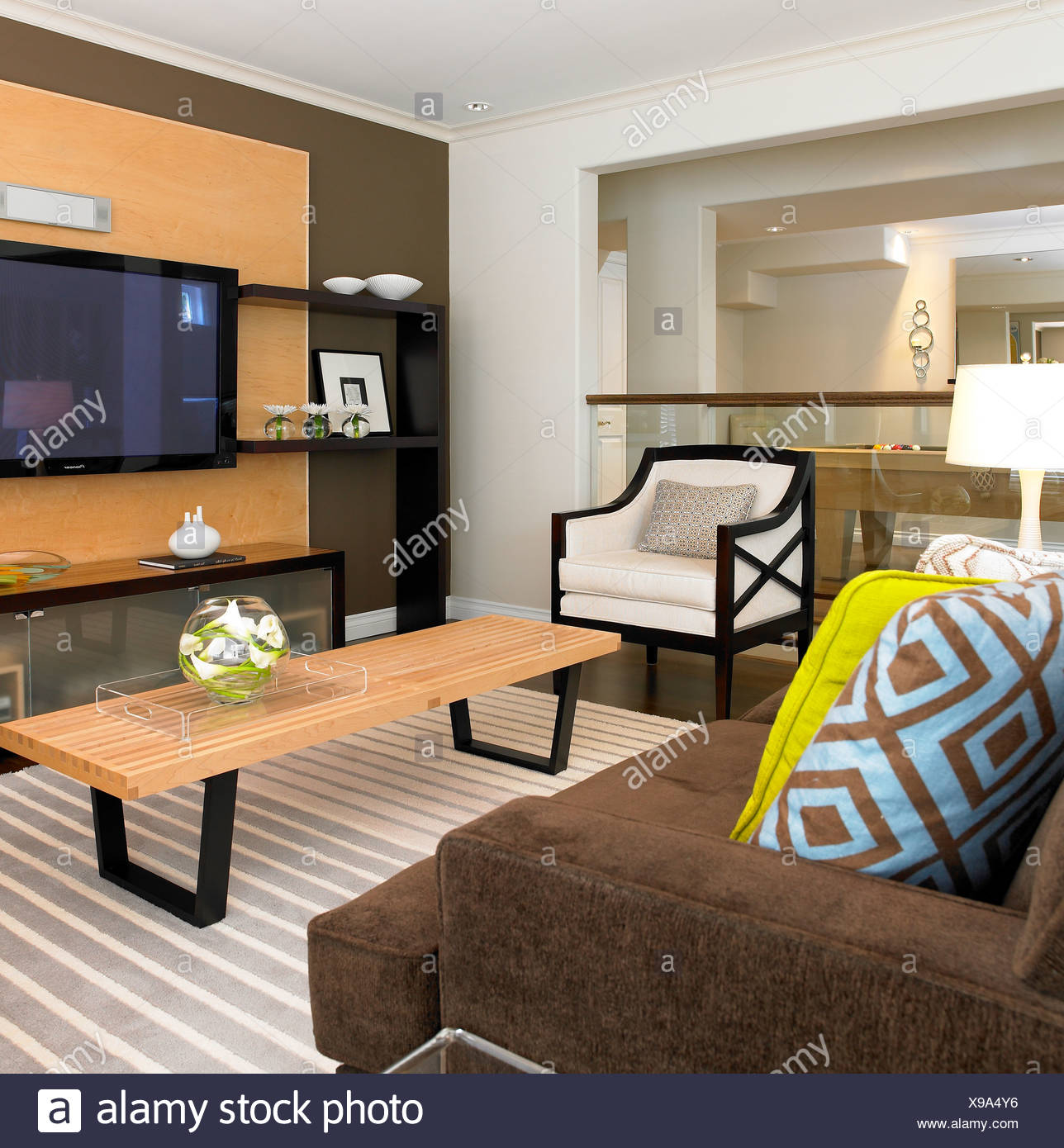 Modern Living Room With Striped Rug And Geometric Pillows