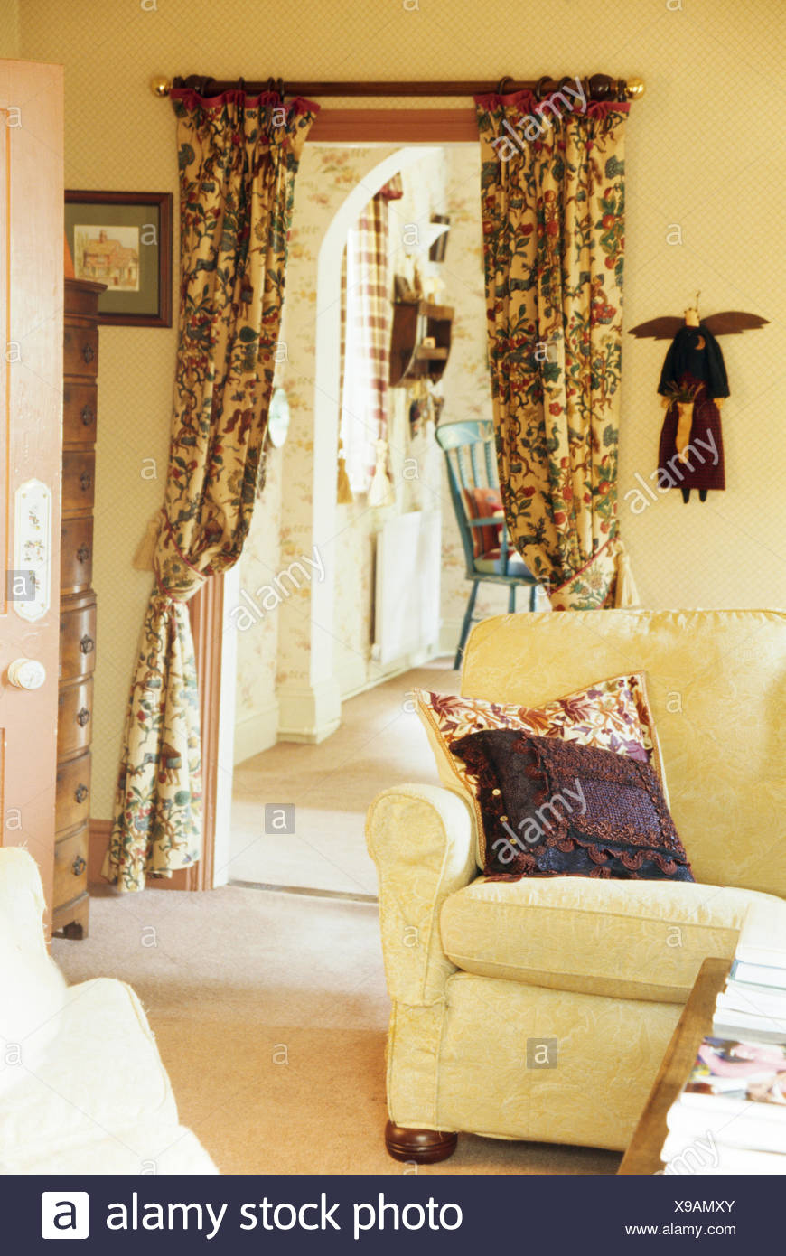 Cream Sofa In Cottage Living Room With Patterned Curtains On