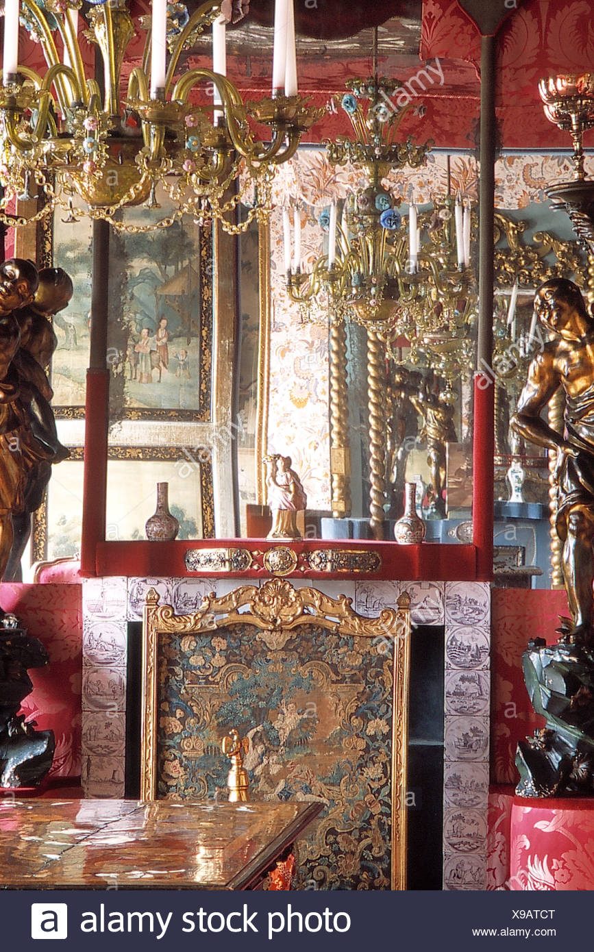 Brass Chandelier In County Dining Room With Large Mirror Above