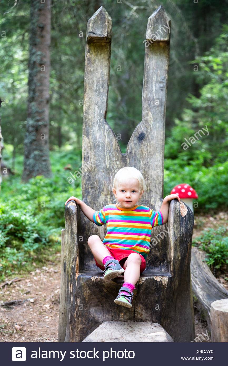 Toddler Sitting On A Big Wooden Chair In The Forest Enchanted Forest In Bernau Black Forest Germany Stock Photo Alamy