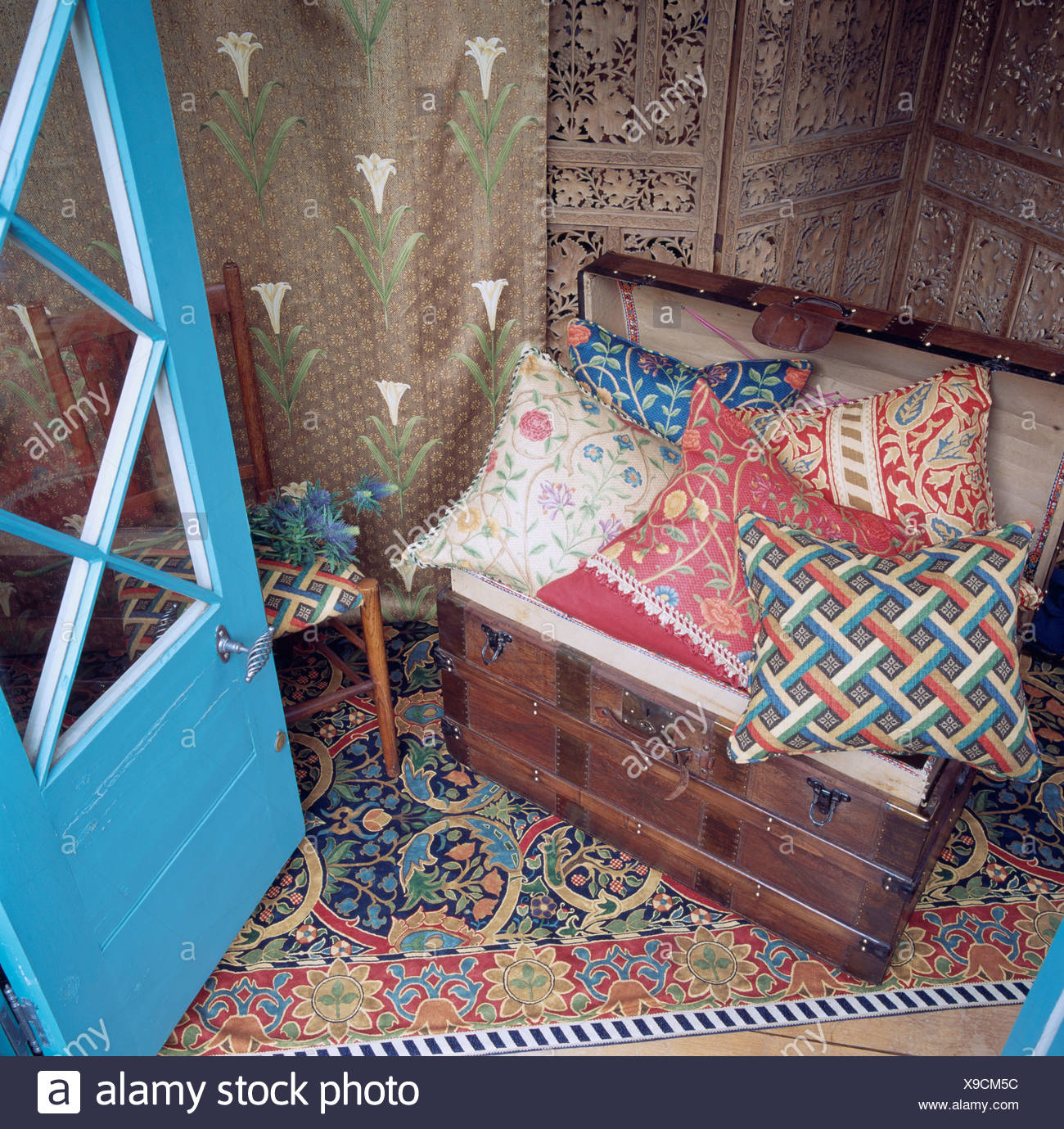 Colorful Patterned Cushions On Old Wooden Chest On Balcony With