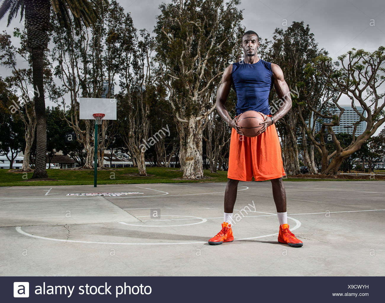 Young Man Playing Basketball On Court Stock Photos & Young Man Playing