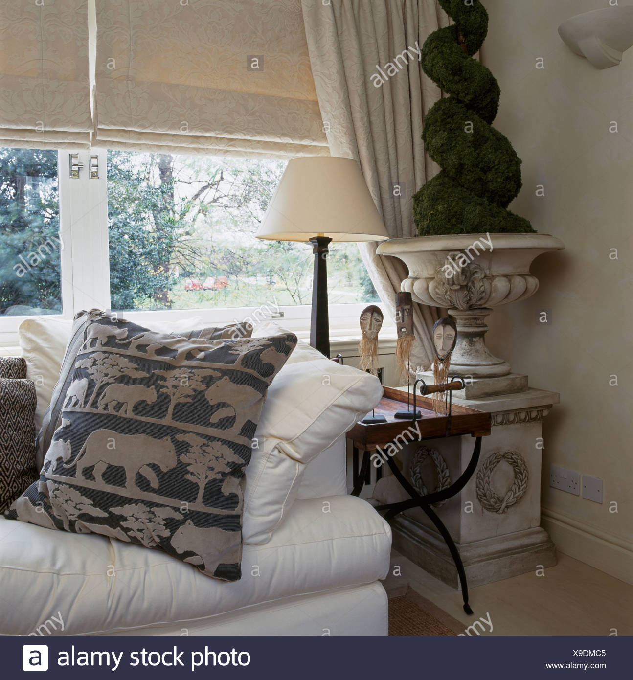 Patterned Cushion On White Sofa In Front Of Window With