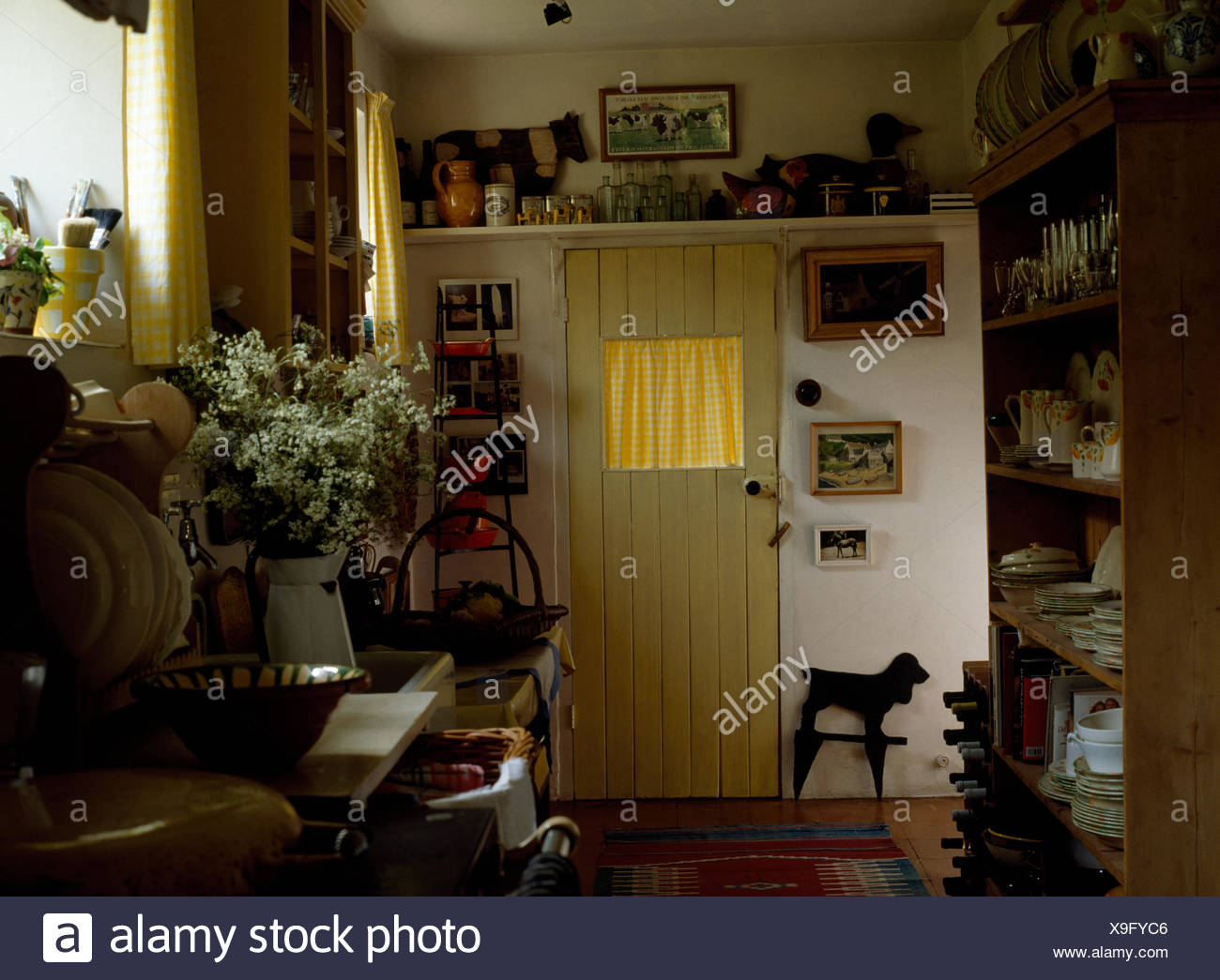 Yellow Back Door In Cluttered Nineties Cottage Kitchen With A Jug