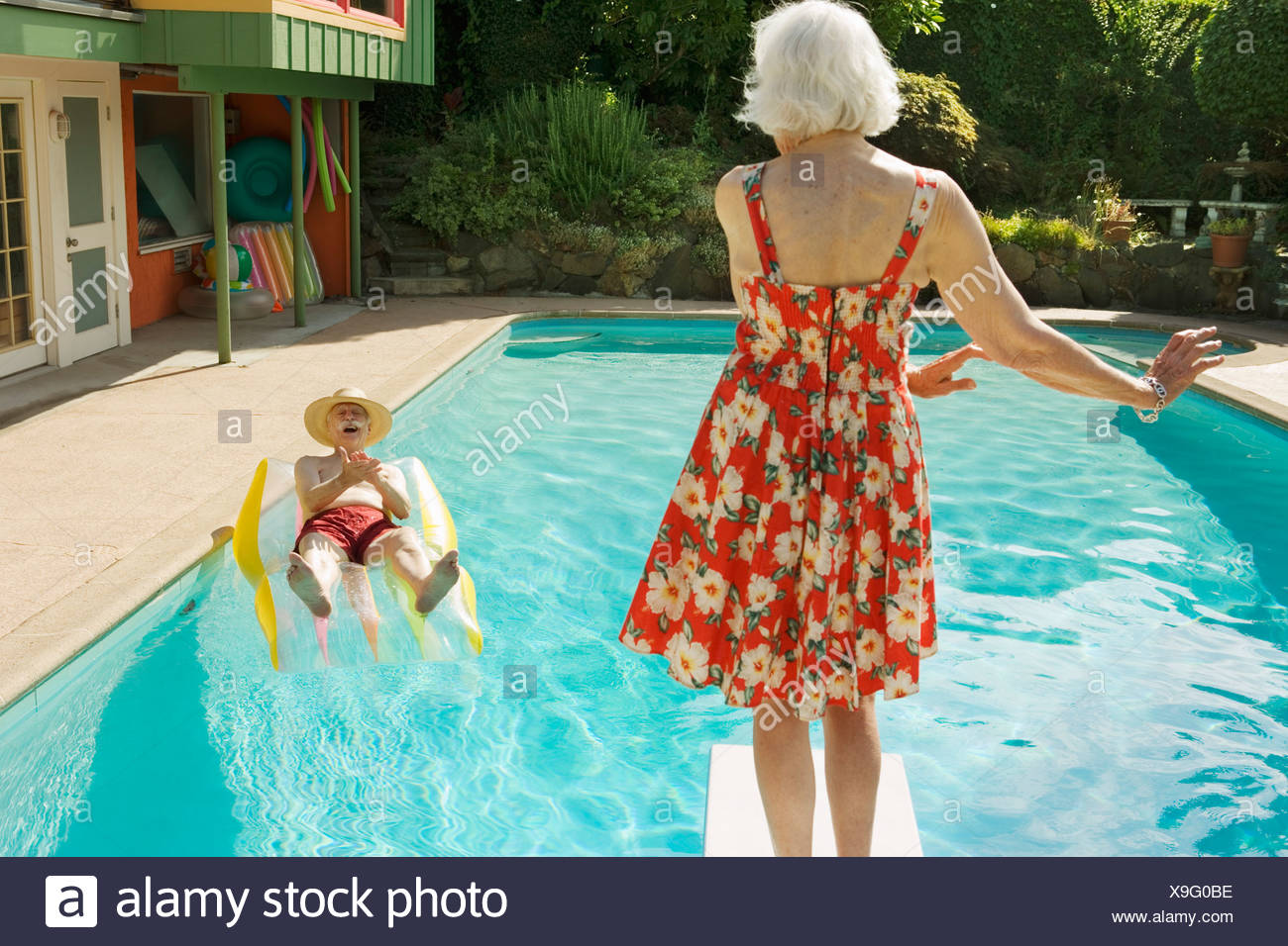 Senior Couple Having Poolside Fun Stock Photo Alamy