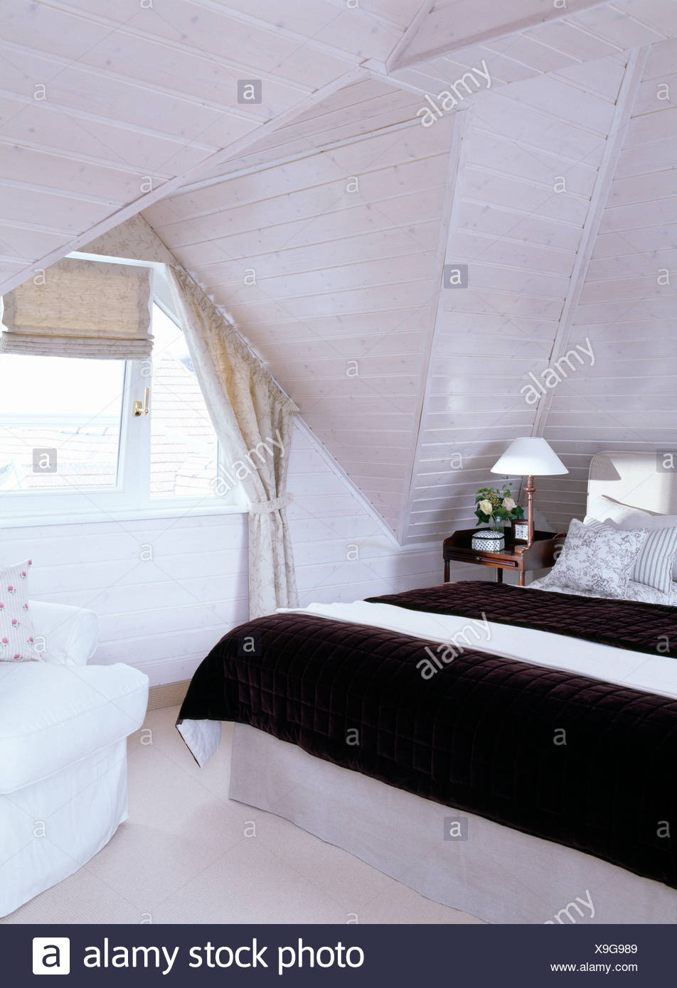 Black Throw On Bed In White Attic Bedroom With White Painted