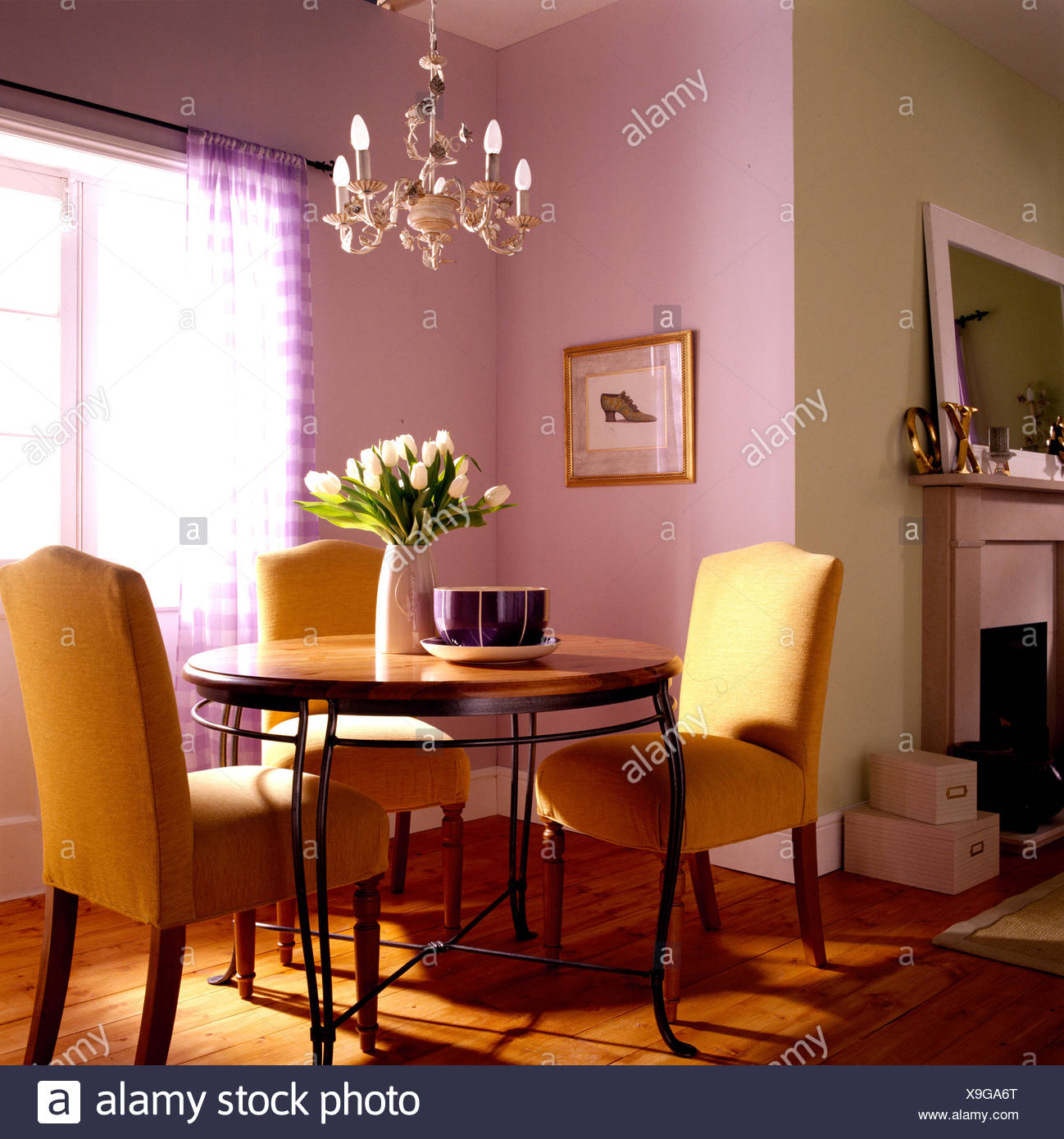 Dining Room With Designer Table And Upholstered Yellow Chairs Stock Photo Alamy