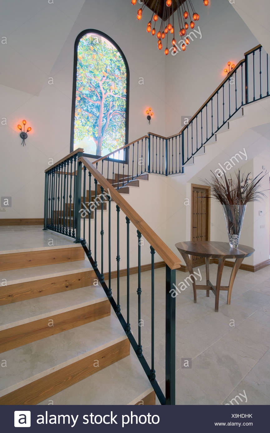 Cast Iron On Modern Staircase In Hall With Orange Wall