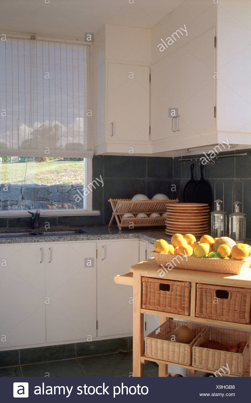 Kitchen White Furniture Lemons In Basket Crockery In Wooden Drainer Stock Photo Alamy