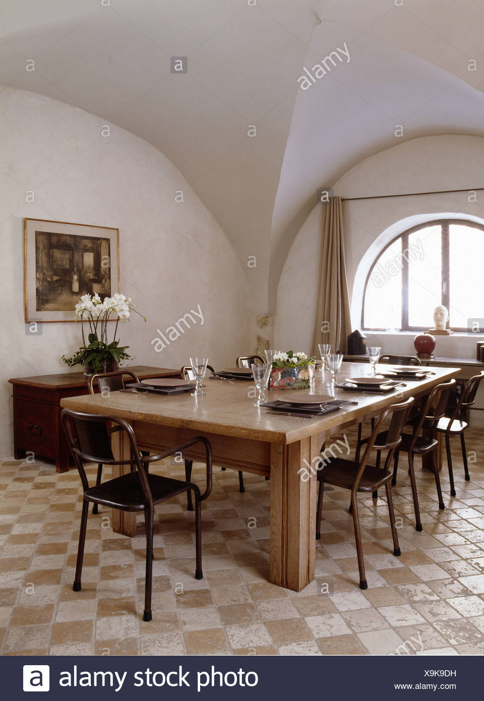Black Metal Chairs At Large Wooden Table In French Country Dining