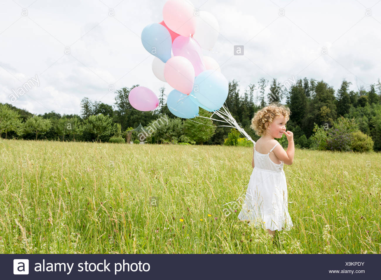 Young Girl Holding Balloons High Resolution Stock Photography and