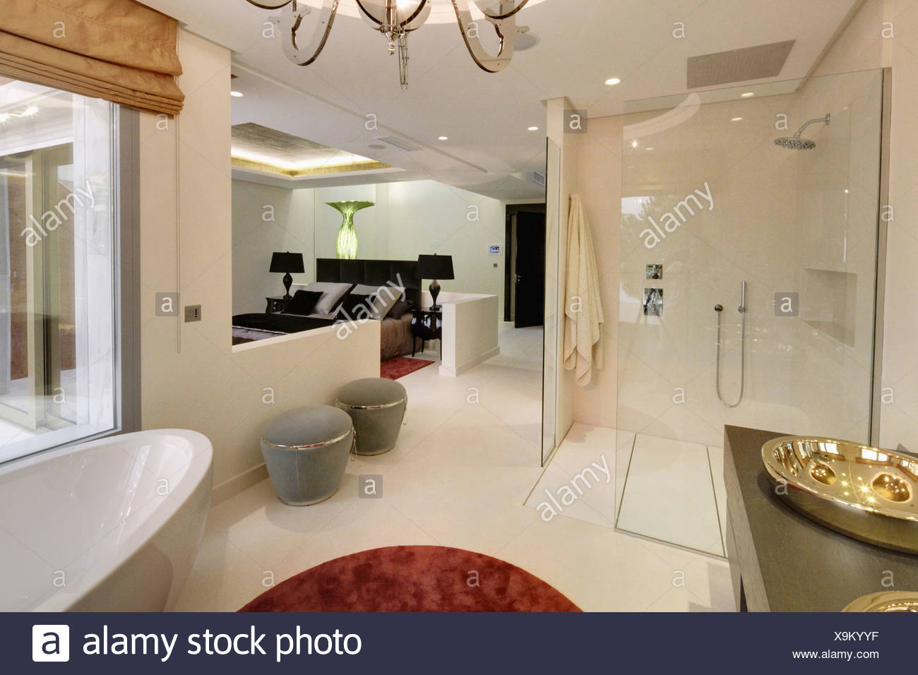 Large Walk In Shower And Gray Stools In Open Plan En Suite Bathroom In Modern Spanish Apartment Bedroom Stock Photo Alamy