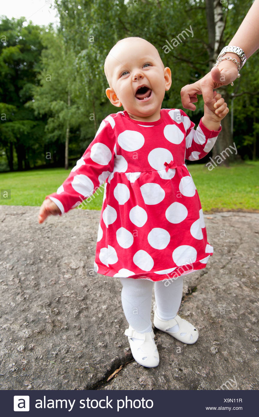 Baby Girl 6 11 Months Holding Mother S Hand Stock Photo Alamy