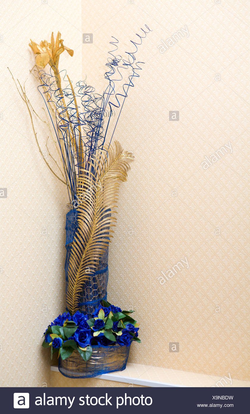 Decor Made Of Vase With Blue Flowers And Golden Feather Stock