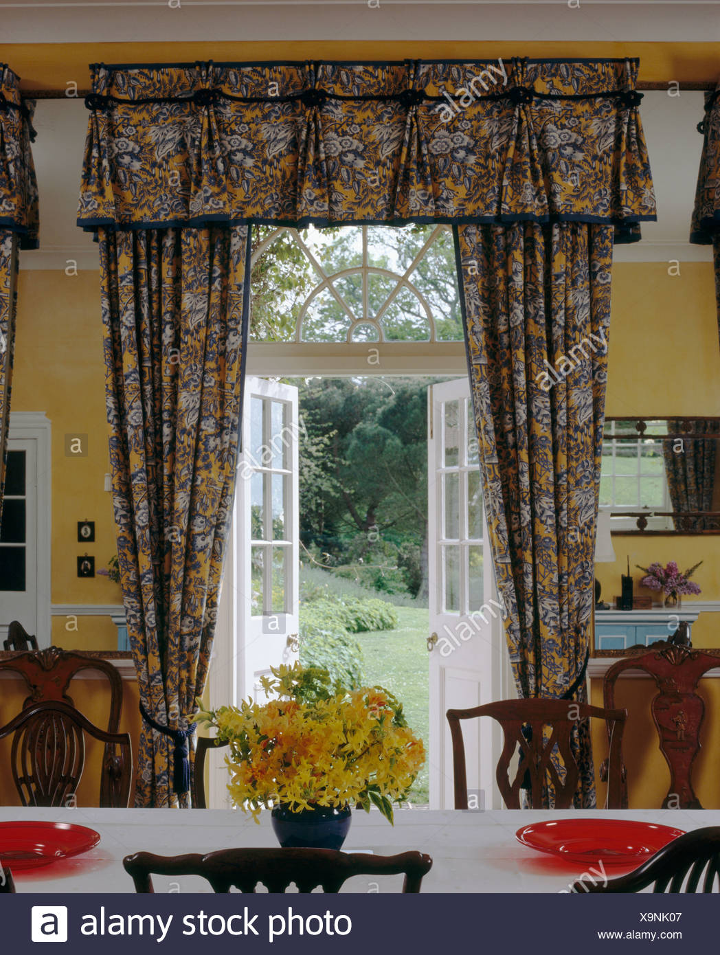 Patterned Curtains With Matching Pelmet At Open French Doors In