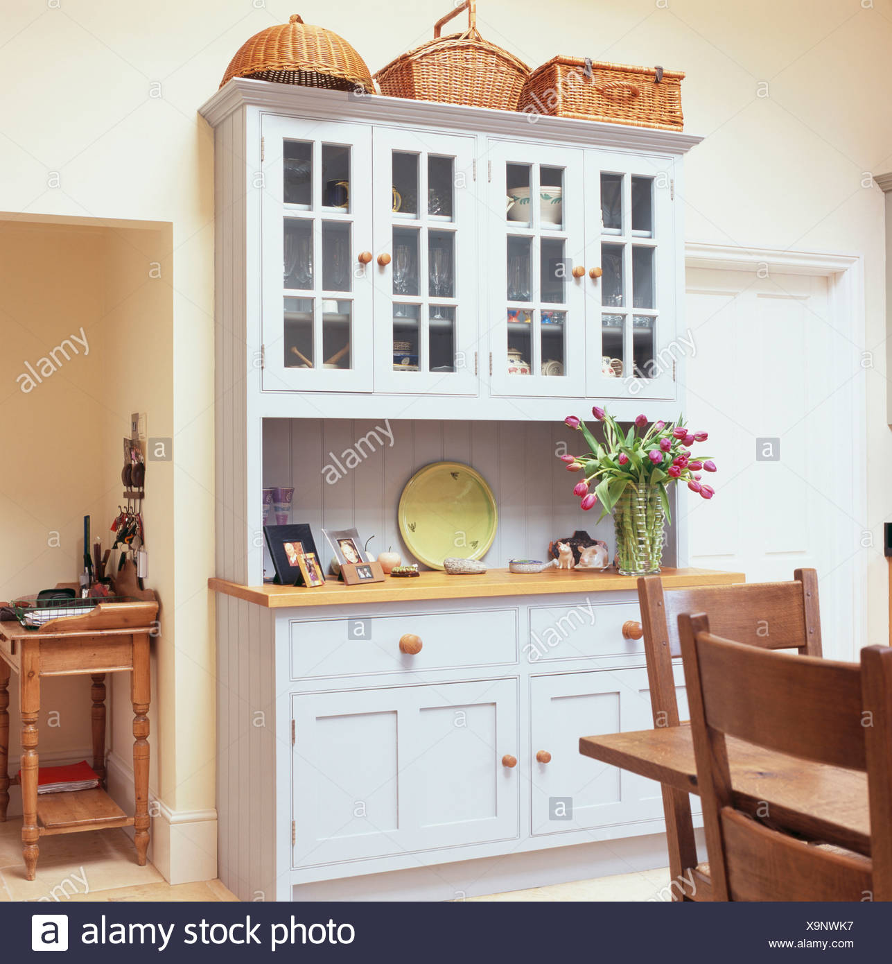 Close Up Of Built In White Painted Dresser With Baskets On Top In