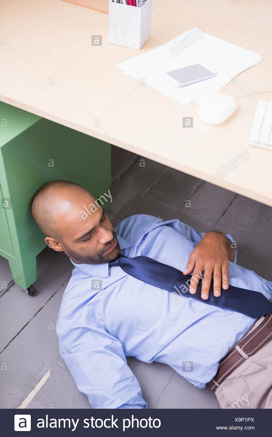 Businessman Sleeping Under Desk Stock Photo 281382162 Alamy