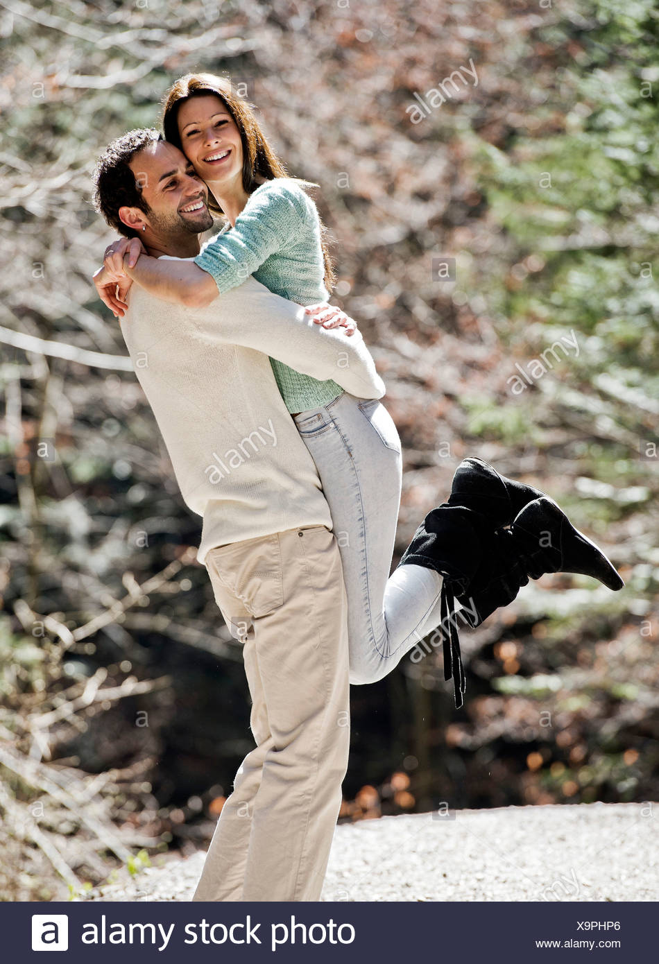 Young Man Picking Up A Young Woman Both Smiling Austria Stock Photo Alamy