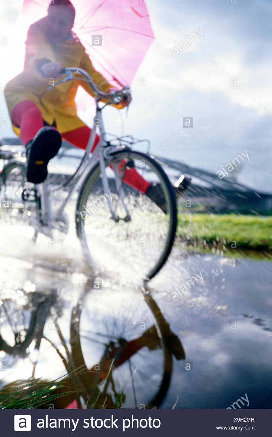 Cyclist With Umbrella Stock Photos & Cyclist With Umbrella 