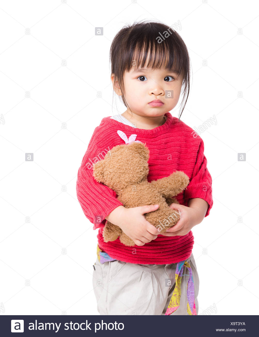 little girl holding doll