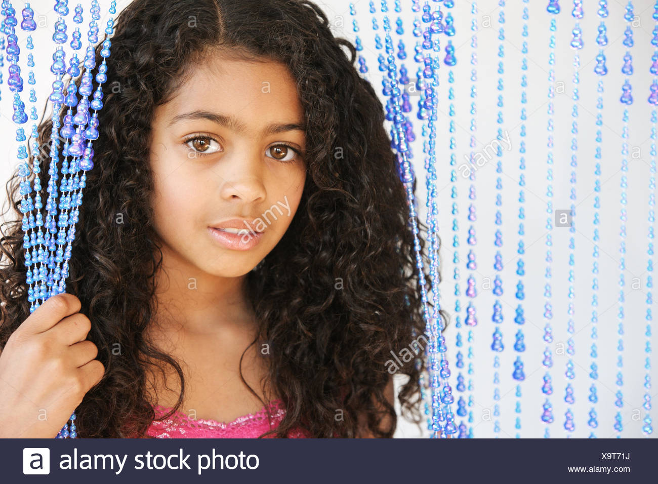 Portrait Of A Young Girl With Dark Curly Hair And Brown