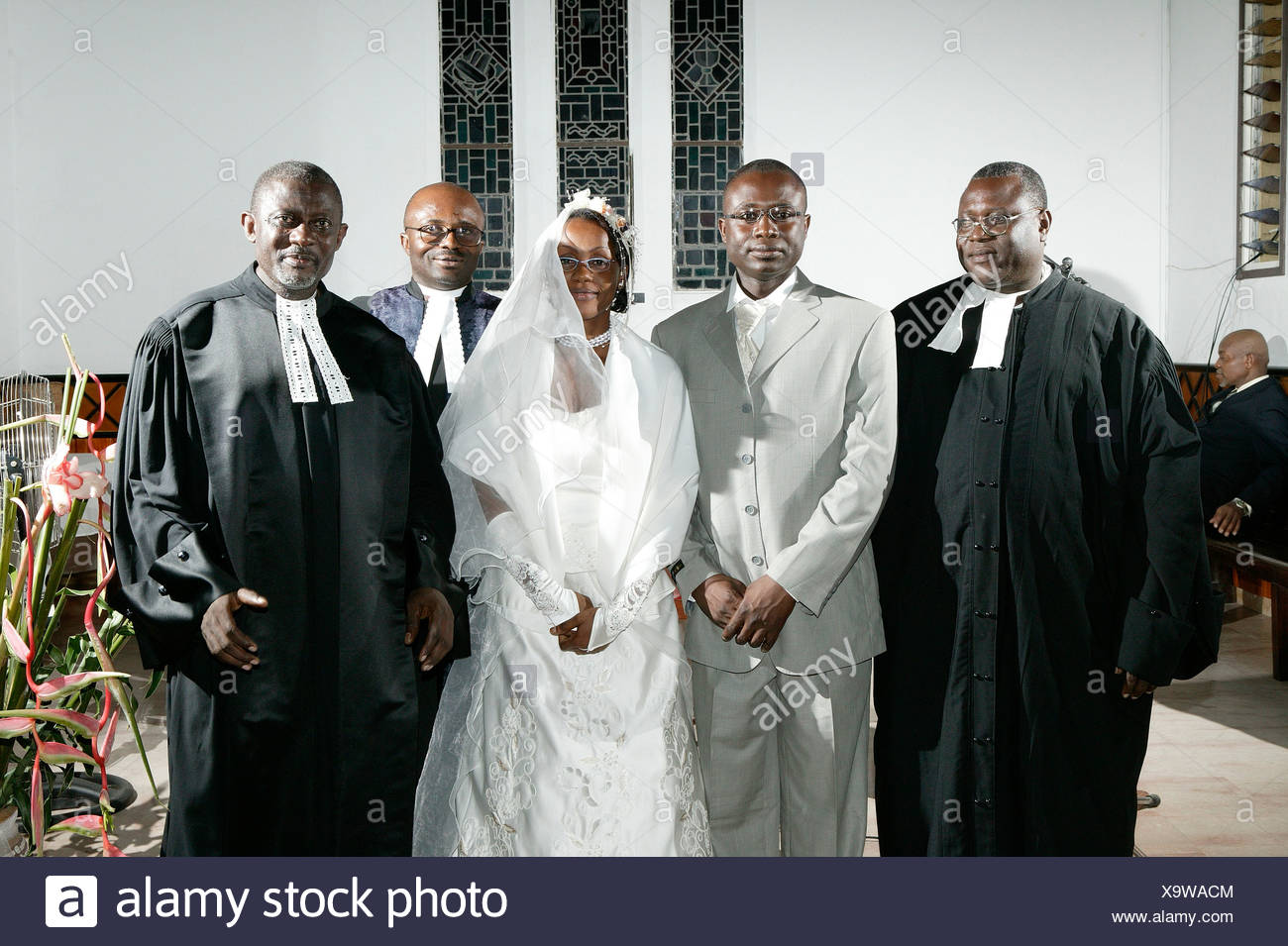 African Bride And Groom Bridal Couple Standing With Pastors At