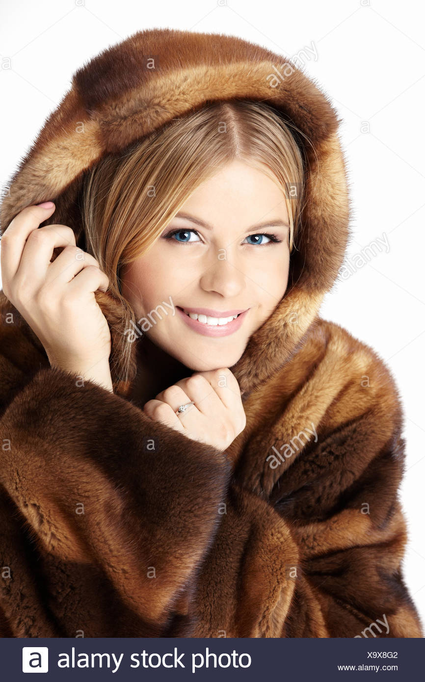 Beautiful blonde in fur coat have thought Beautiful blonde in fur coat