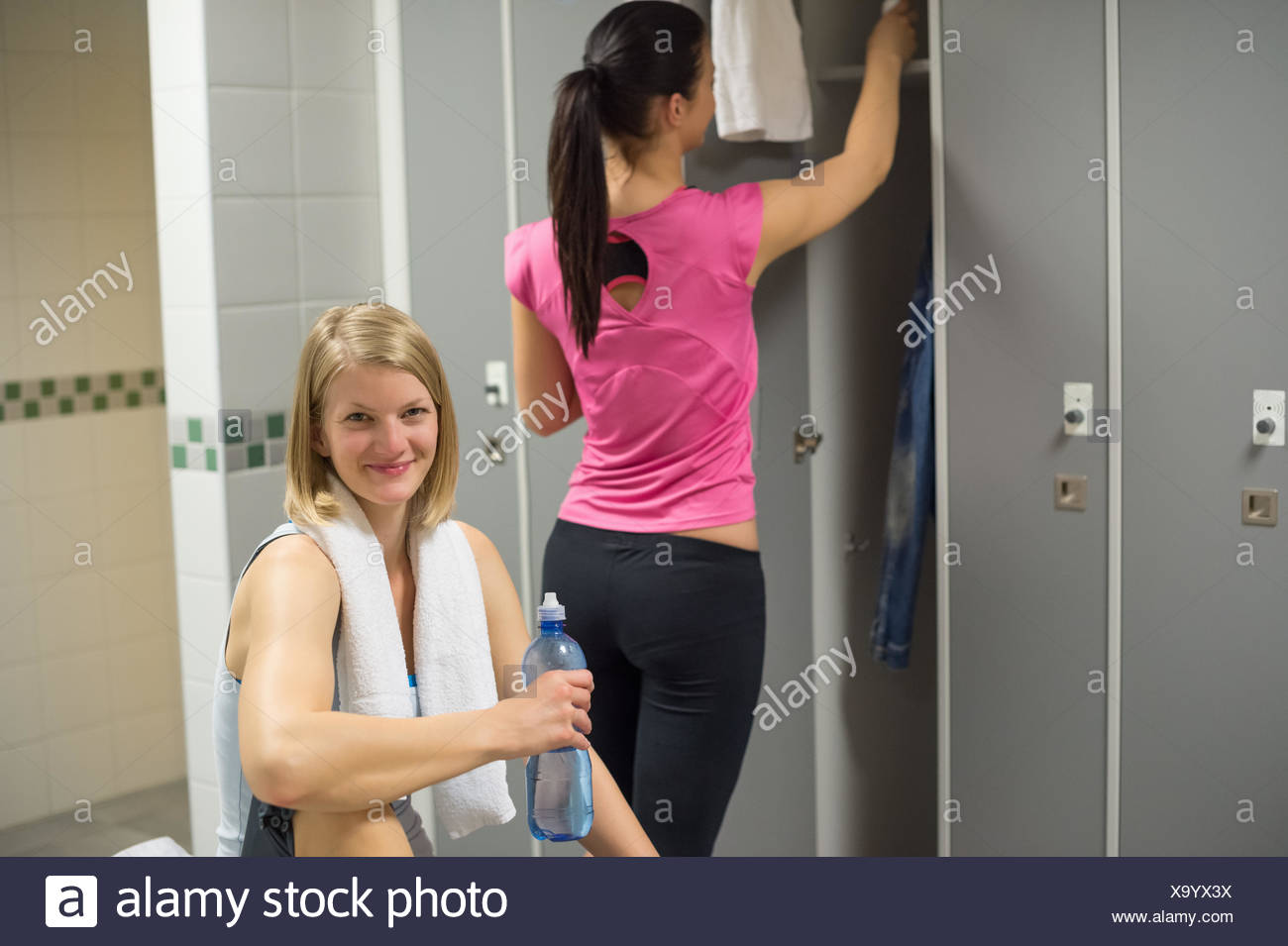 Sport Woman With Friend In Background At Gym S Locker Room