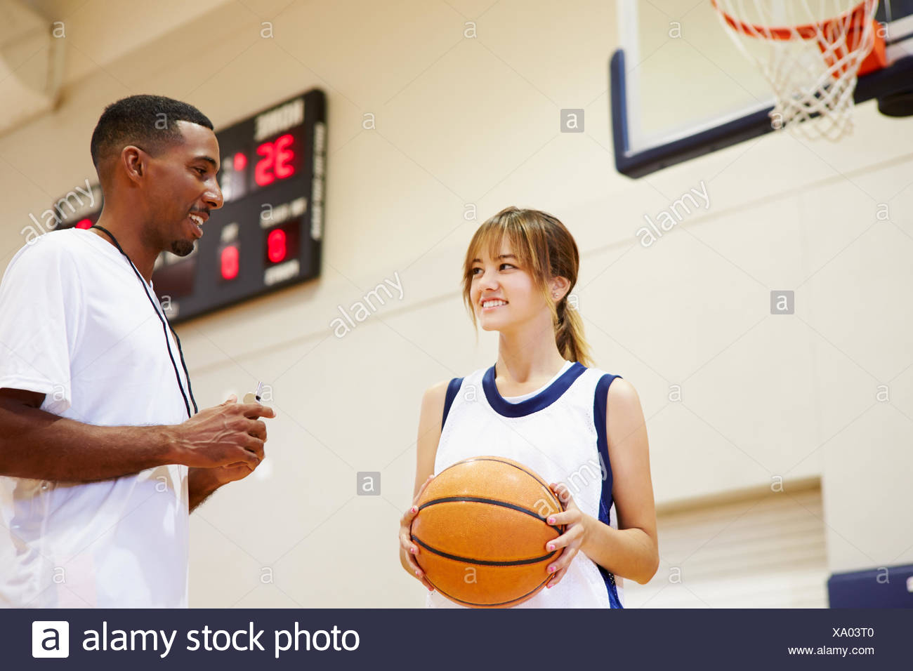 Female High School Basketball Player Talking With Coach Stock Photo - Alamy