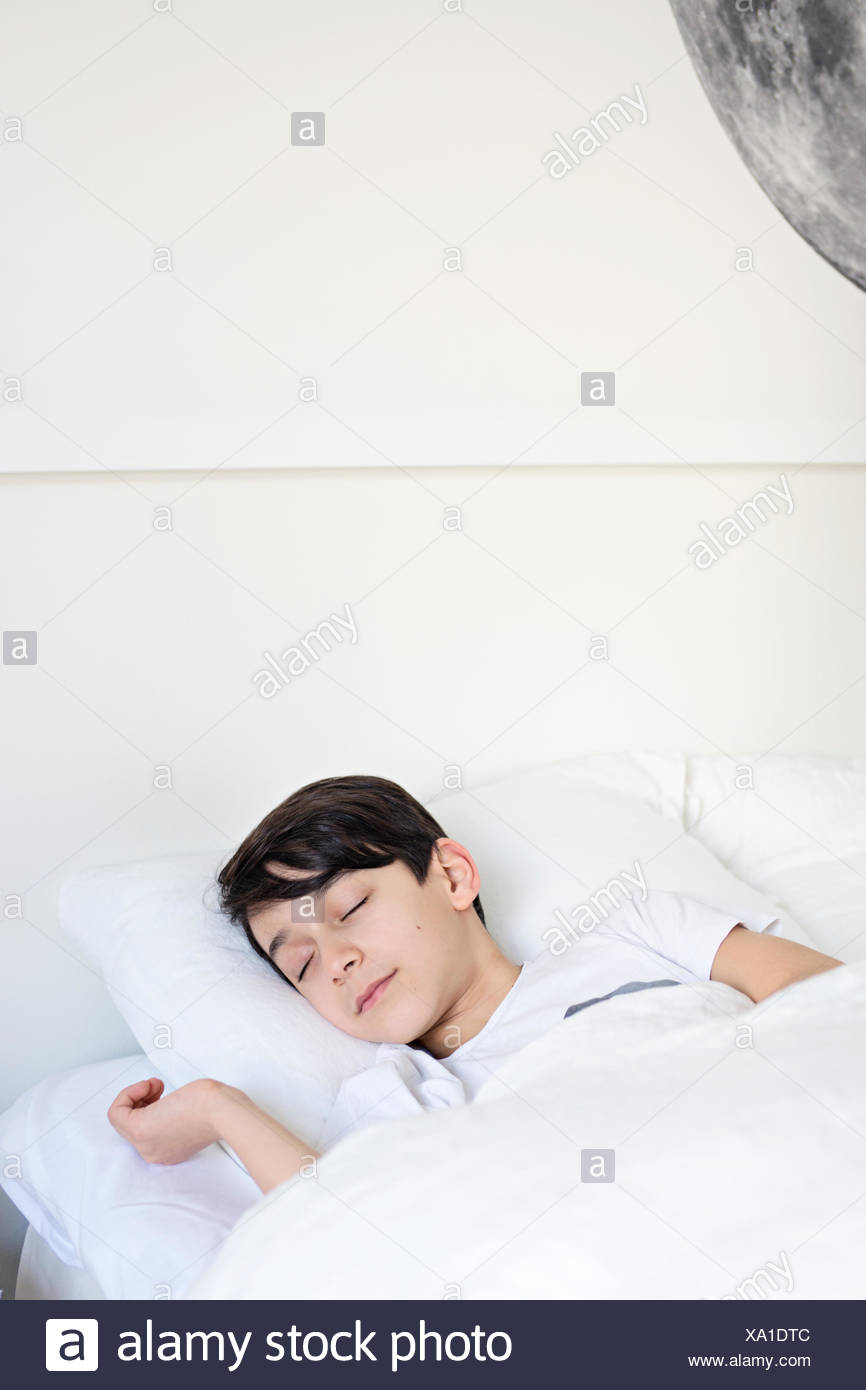 Teenage Boy Sleeping On His Bed High Resolution Stock Photography and