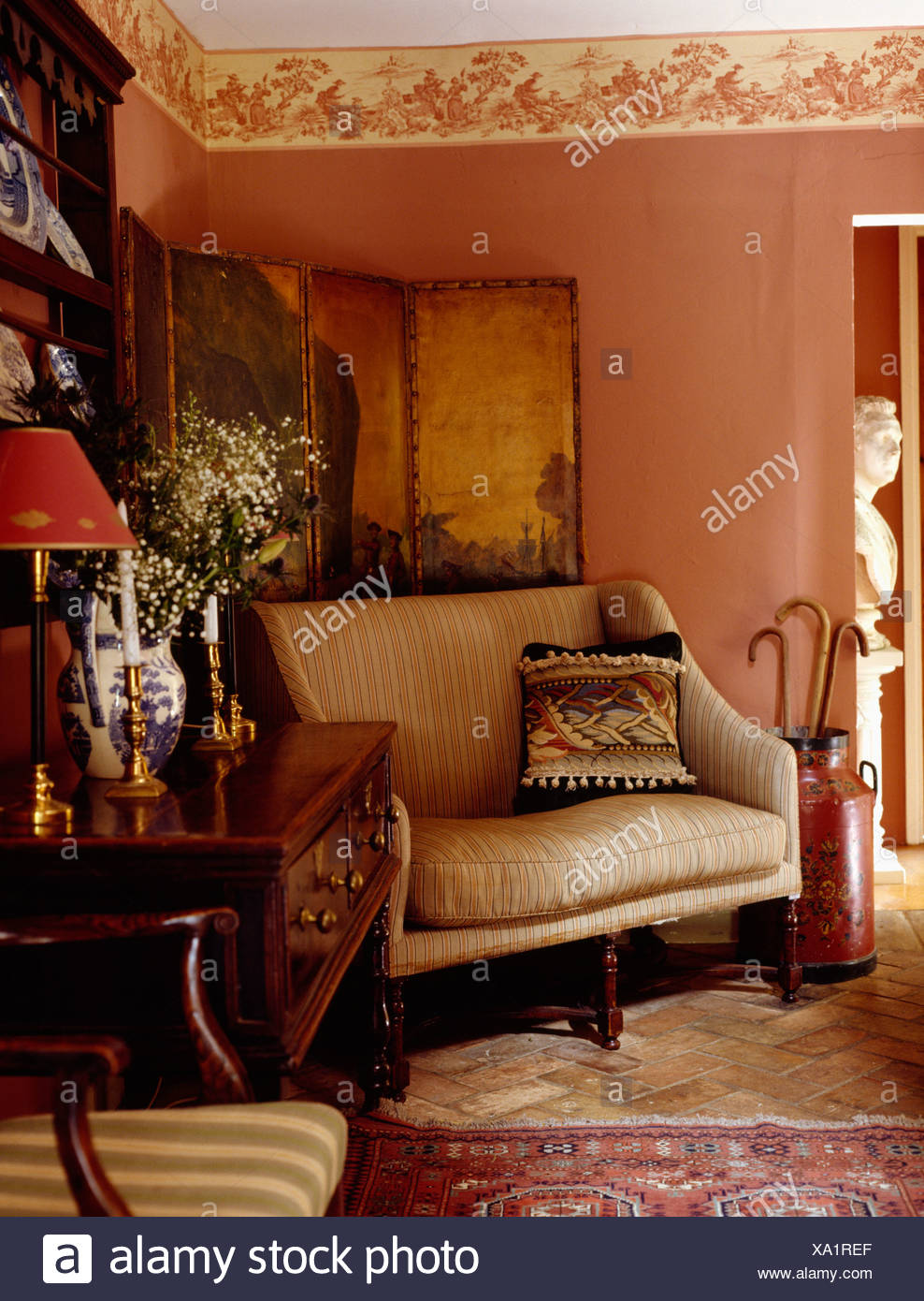 Cream Sofa In Front Of Antique Painted Screen In Pink Cottage