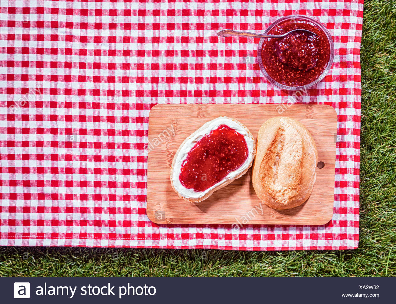 Strawberry Preserve With A Fresh Crusty Roll On A Wooden Bread