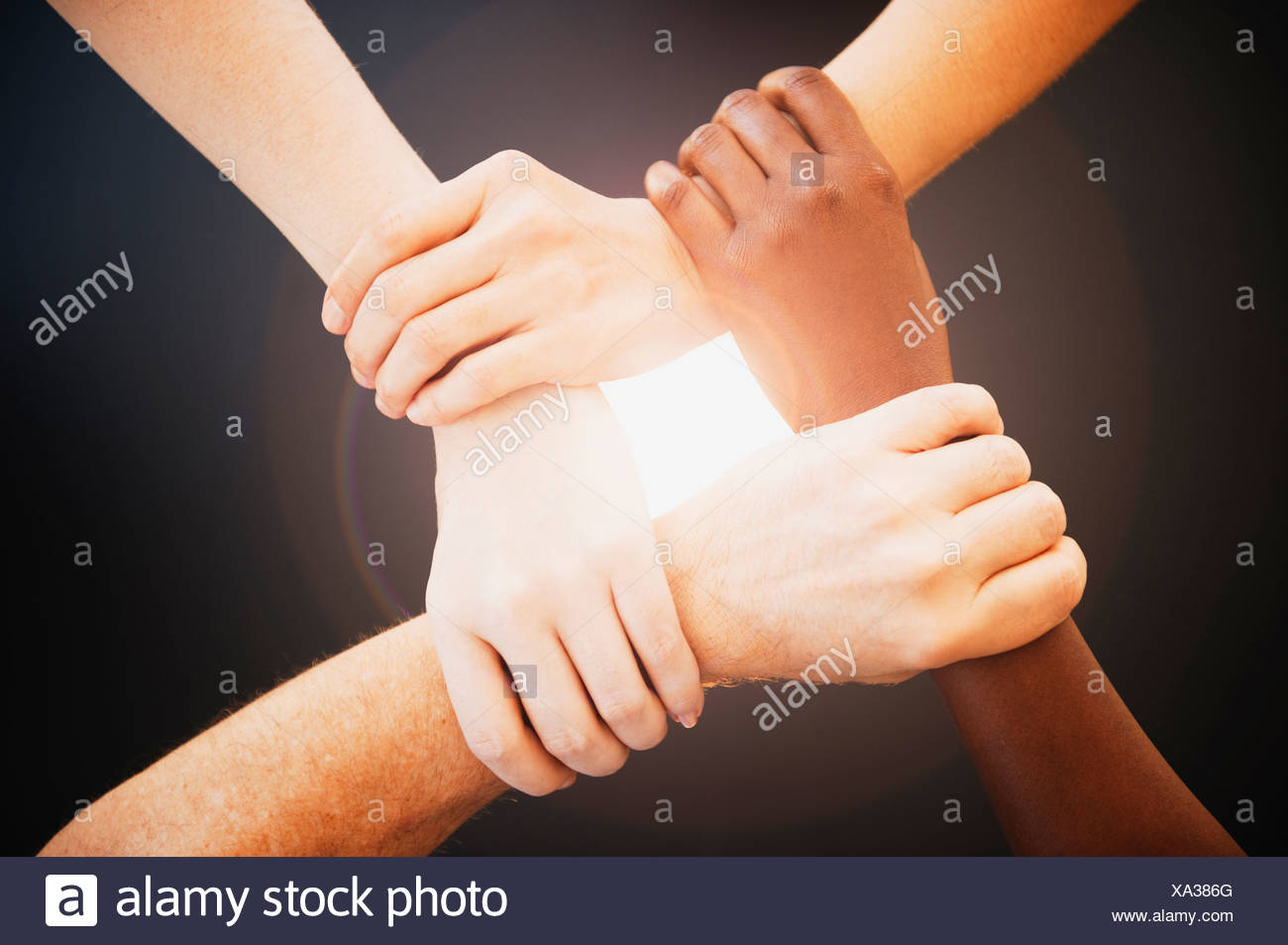 Four Hands Holding Other Wrists High Resolution Stock Photography and