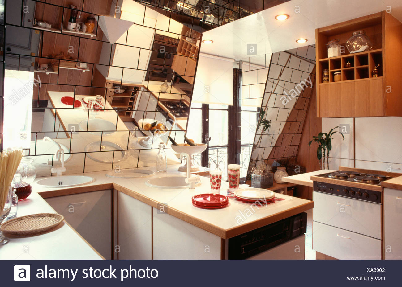 Small Attic Eighties Kitchen With Mirror Tiles On Sloping Walls Stock Photo Alamy
