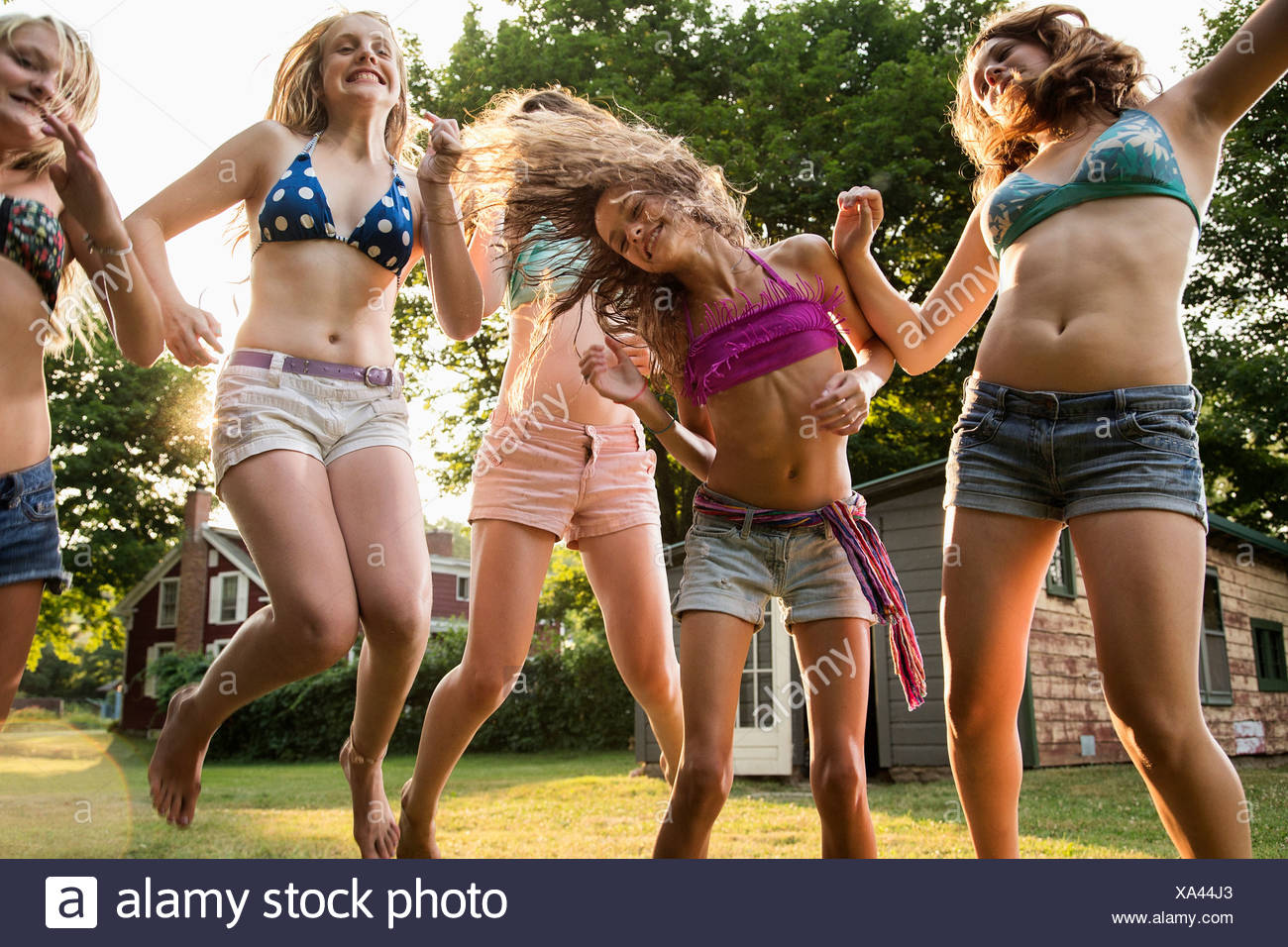 Girls dancing in garden Stock Photo