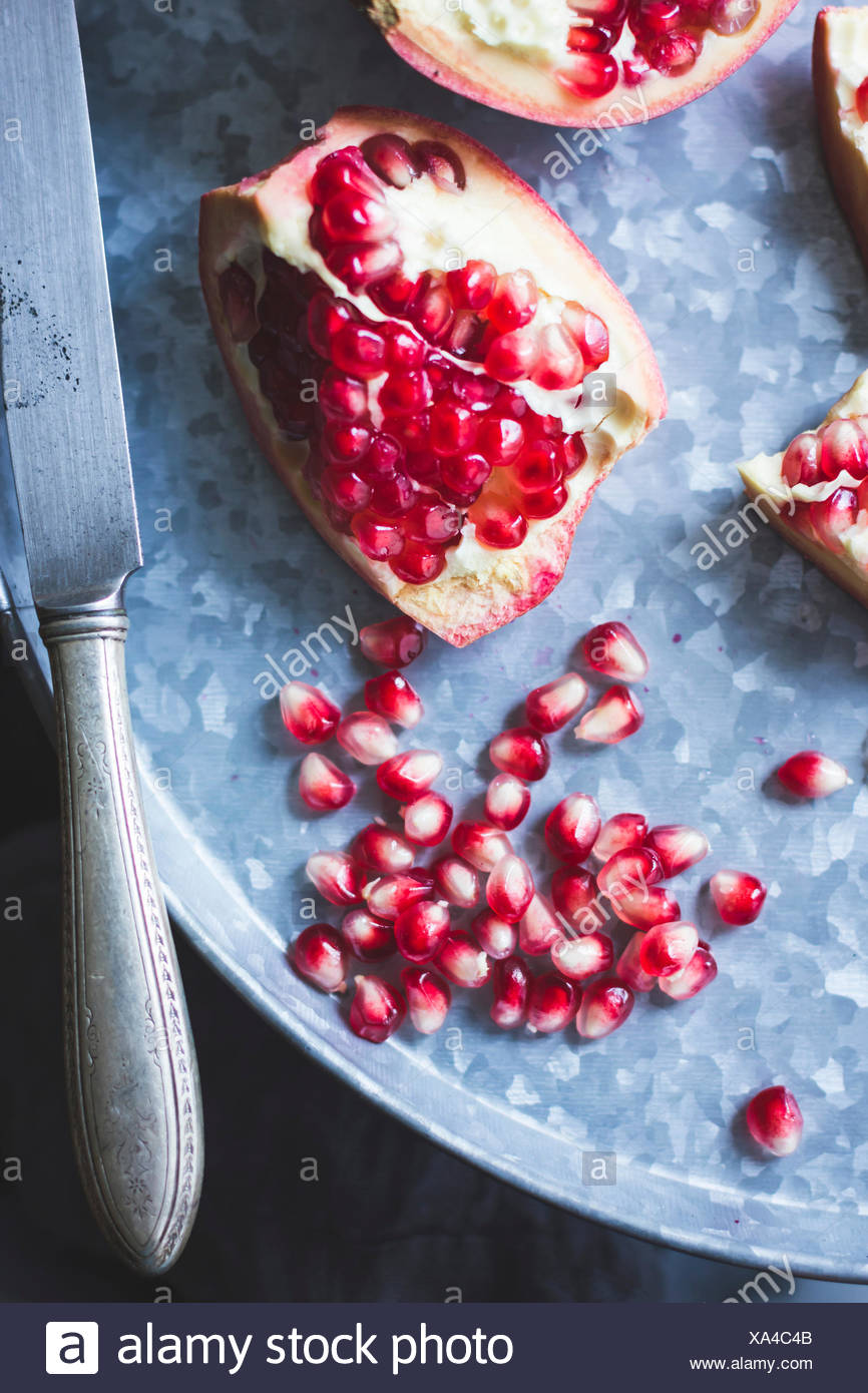 Pomegranate and seeds on a tray Stock Photo