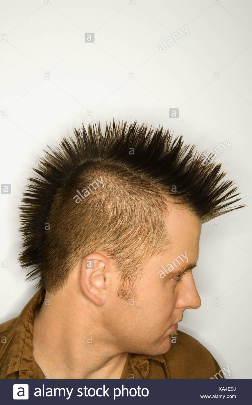 Side View Of Caucasian Man With Mohawk Against White